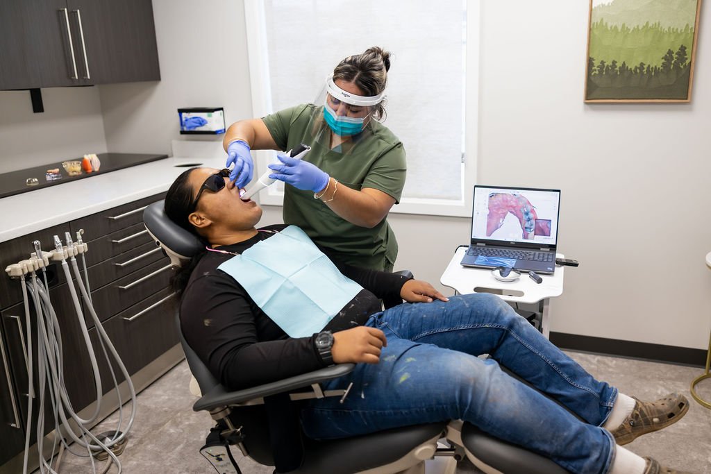 Dentist performing full arch restoration